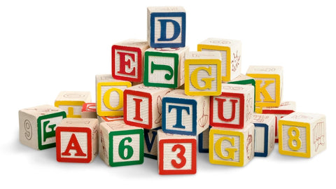 Alphabet toy blocks stacked in a pyramid manner on the floor