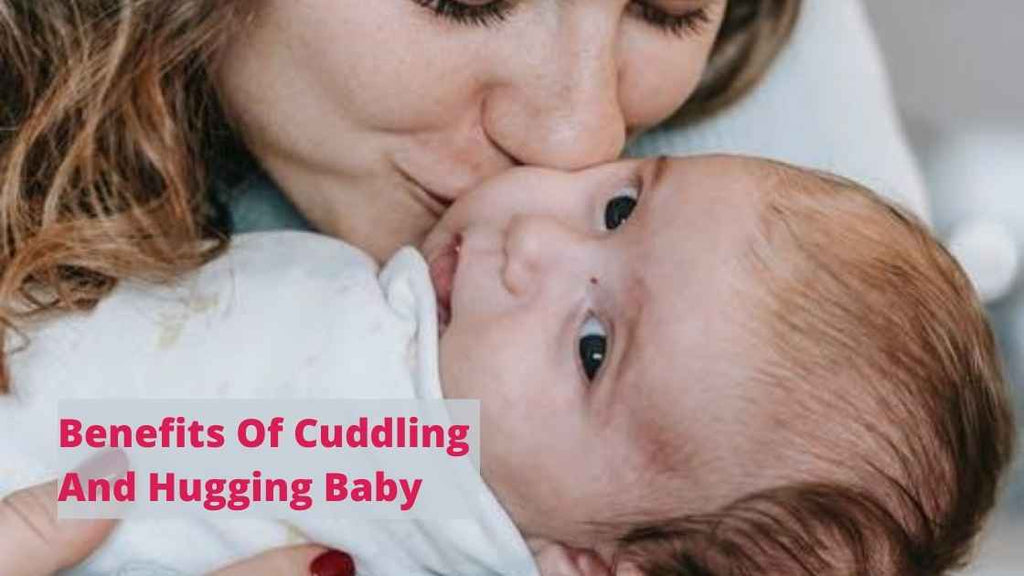 Woman kissing and cuddling a baby