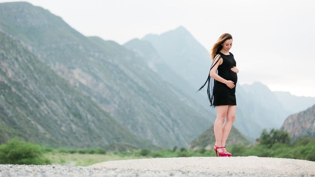 pregnant woman outdoors in high heels