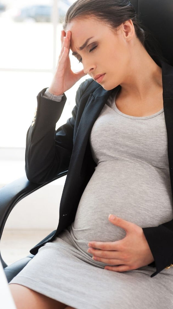 pregnant woman tired holding her head