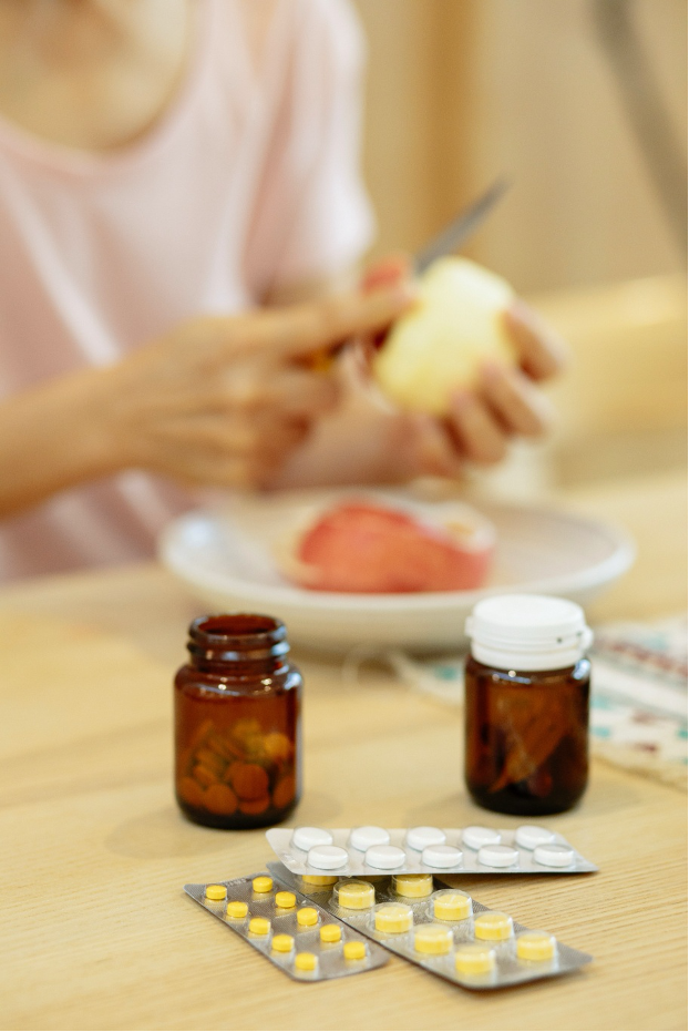 woman preparing meal with her vitamins