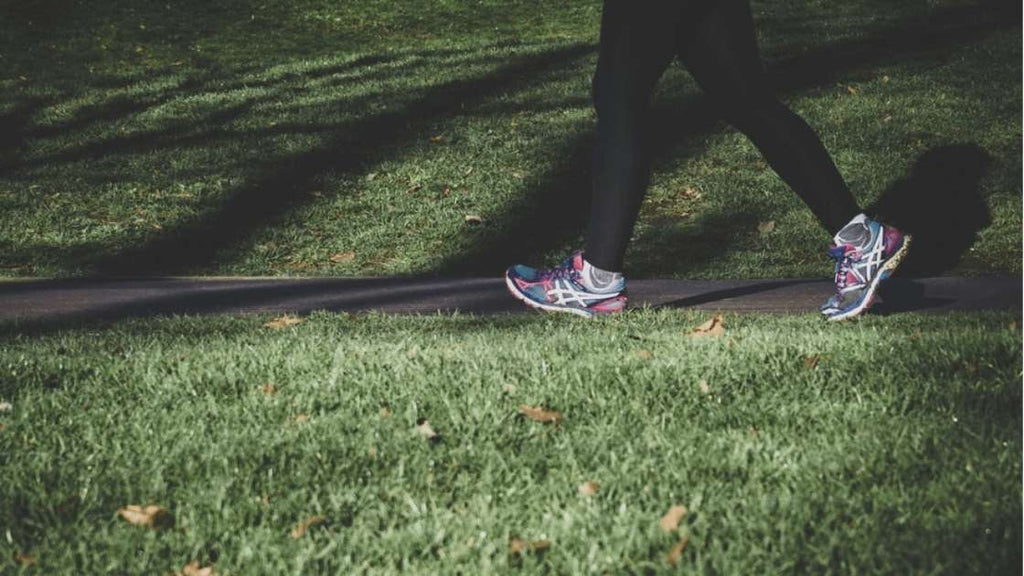 woman's legs walking in a park