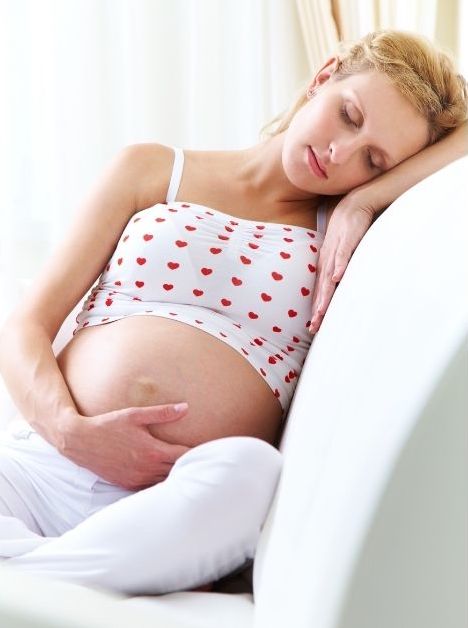 pregnant woman sleeping upright on couch