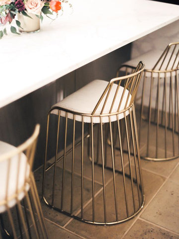 Decorate your living room spaces with stools and tables with tasteful brass accents.