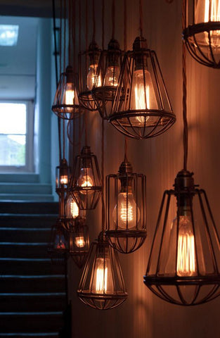 Jazz up your lonely staircase with a charming cage pendant light overhead. It dangles like a gem from atop, creating a more sophisticated look on your lofty hallways.