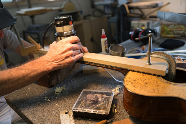 Lining up the Jig on a Guitar Repair at Mass Street Music