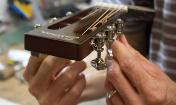 eastman-guitar-headstock-being-tuned