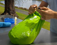 Clip the ends of the seal together to close the Scrubba wash bag
