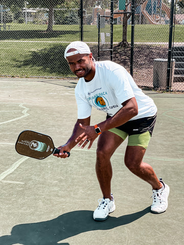 pickleball player with revolin sports paddle hitting forehand drive