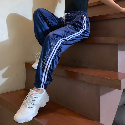 blue track pants with white stripe