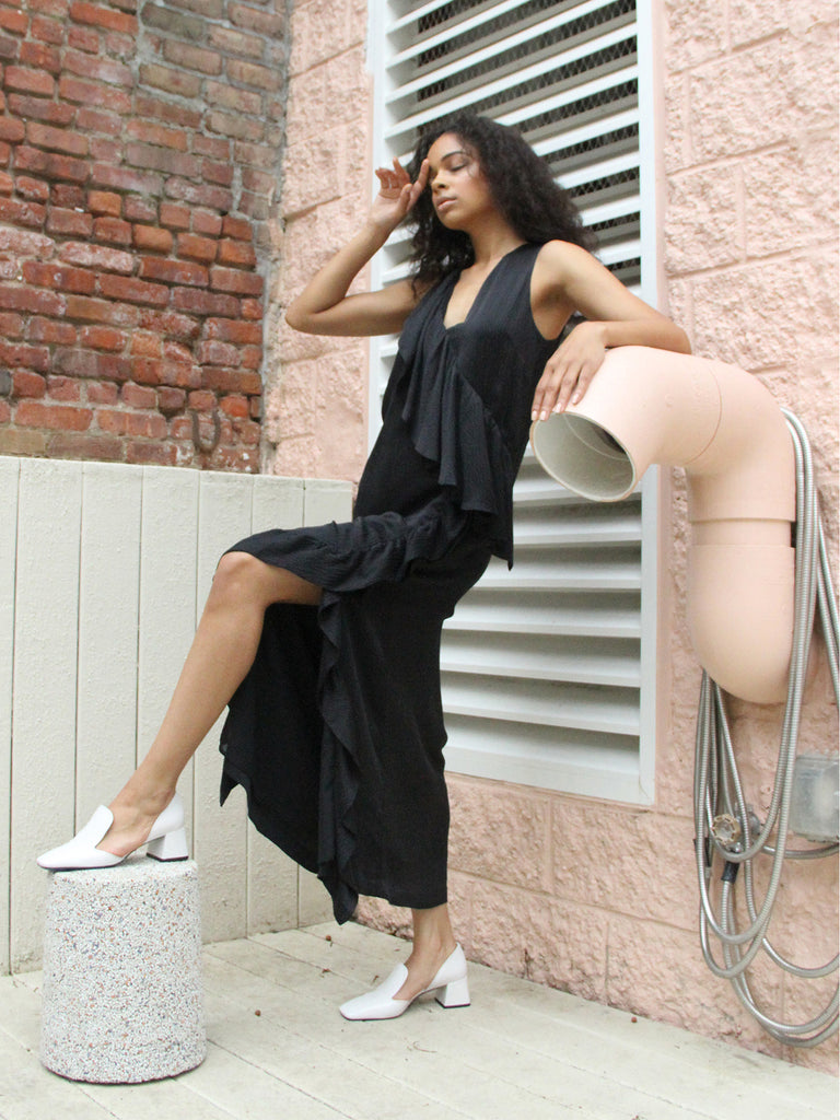 Sleeveless black maxi dress with cascading ruffle detail by Rodebjer