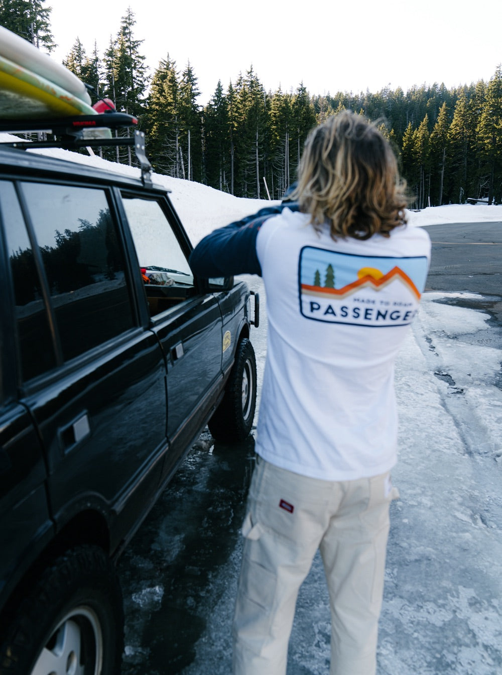 Brandon Haley stands next to his 4x4 wearing a passenger L/S t-shirt