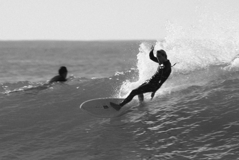 A surfer performs a stylish cut back of a glassy wave