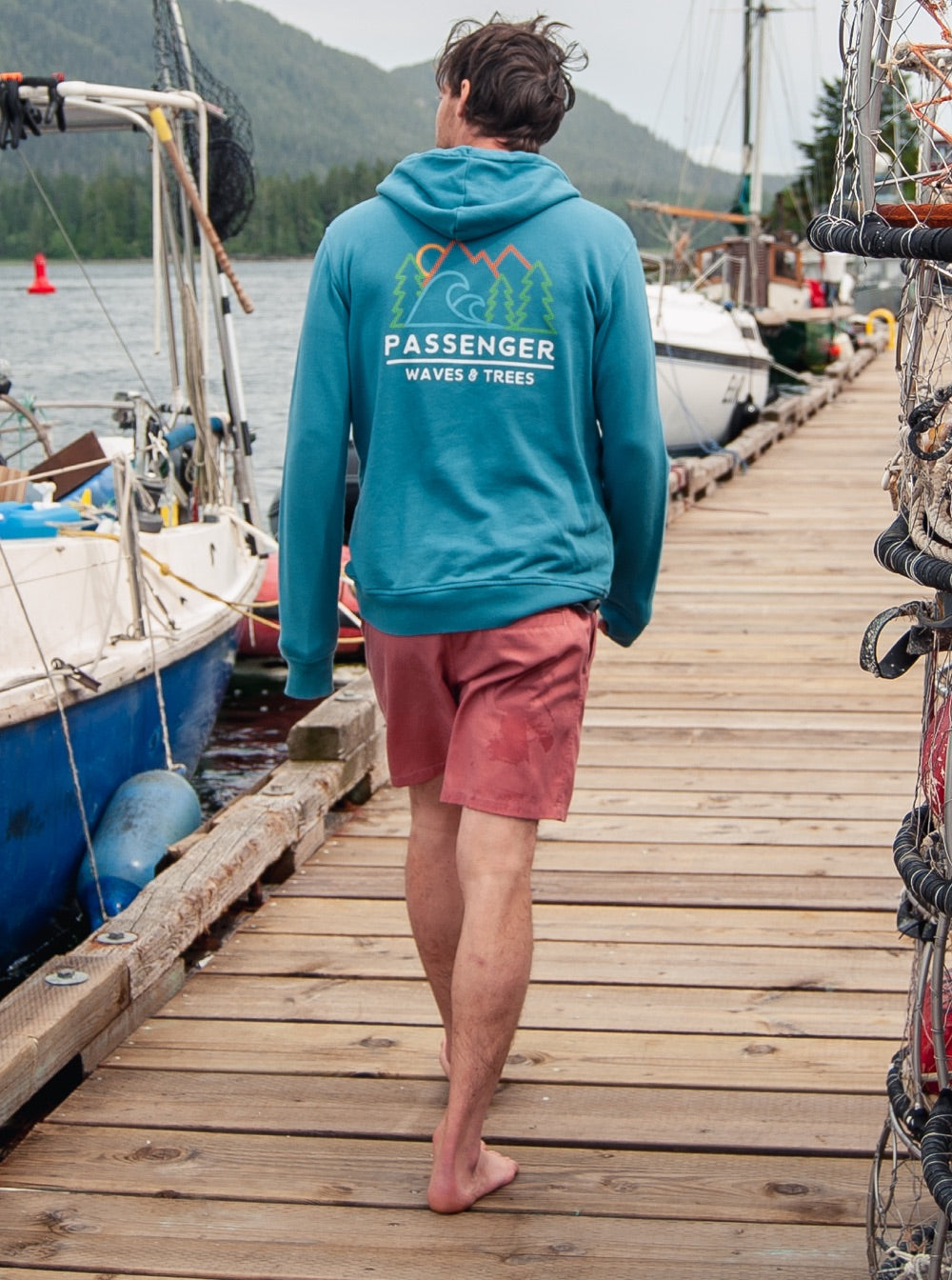 Man walking along a pontoon wearing Tahoe shorts