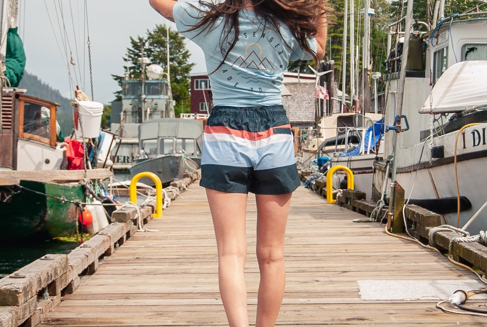 Woman walking along pontton in Horizon hybrid shorts