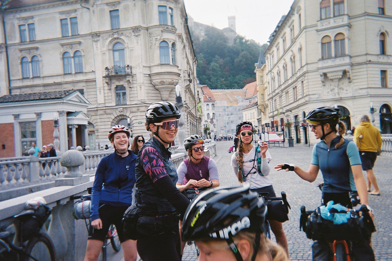 A group of women on bikes stopped in the street