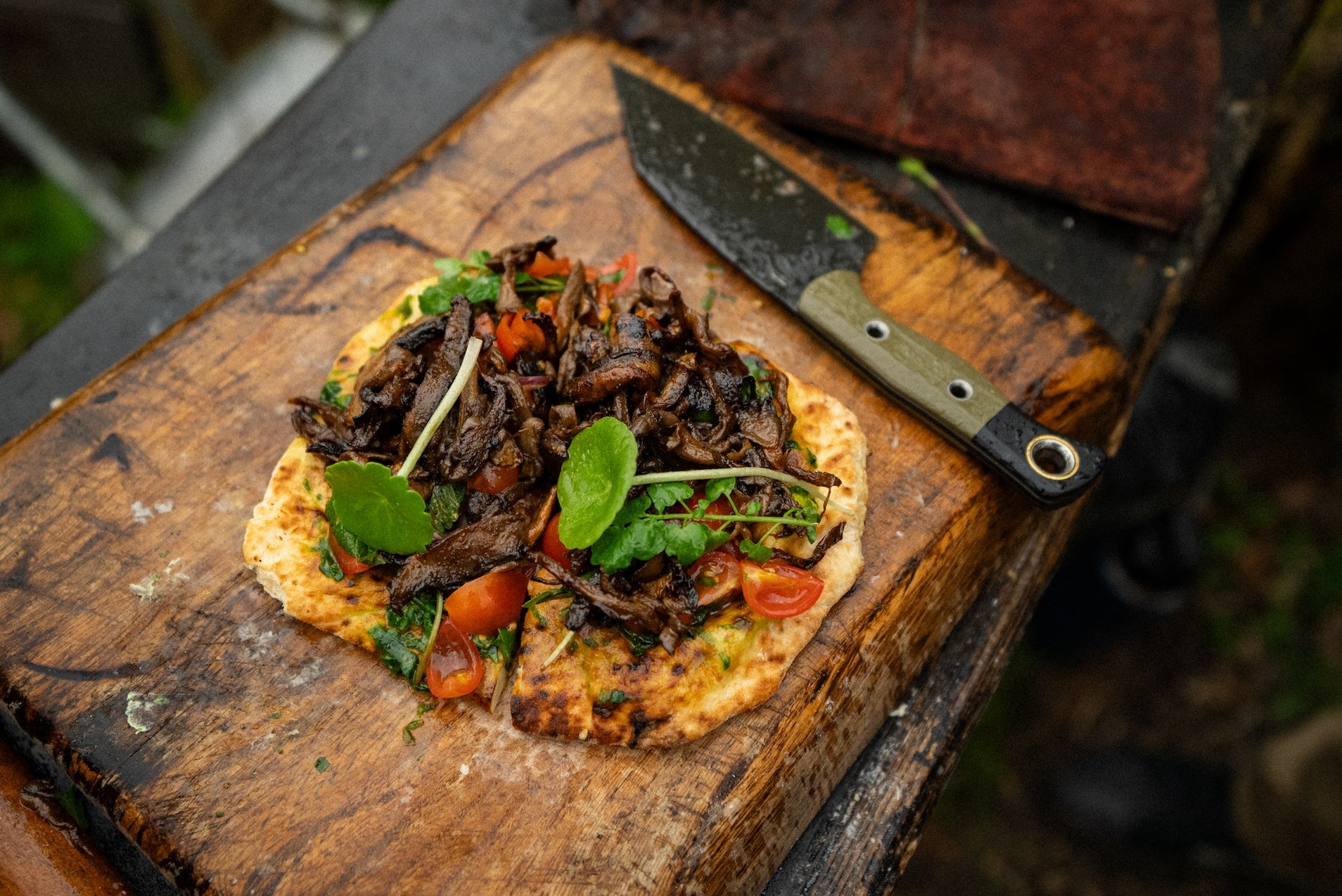A freshly cooked wood-fired mushroom shawarma recipe on a rustic chopping board