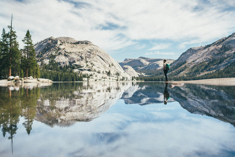 Maggie on a lake looking at mountains