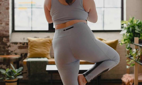 person standing wearing gray leggings and gray bra