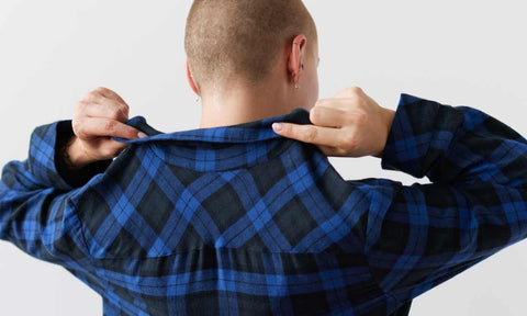 person wearing blue and black flannel pajamas