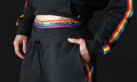 person wearing black and rainbow pride outfit