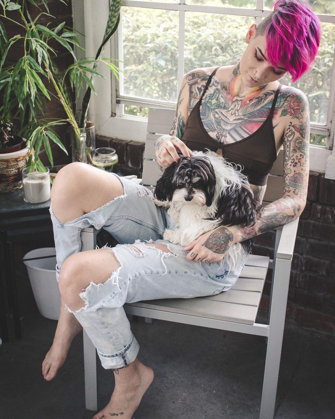 Wearing bralette sitting in a chair with a dog