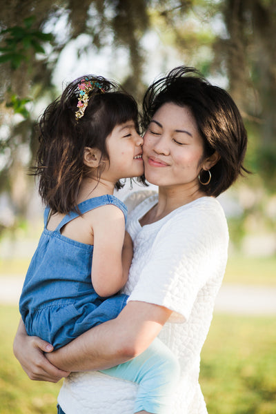 Mom poses with her baby in her arms. Generative AI 30502810 Stock Photo at  Vecteezy
