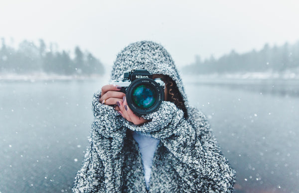Woman taking picture in the snow