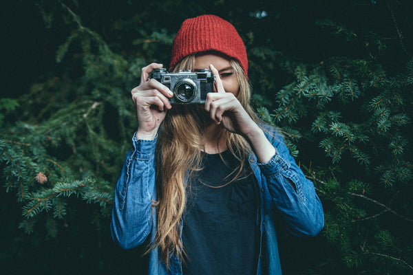 Woman taking pictures in the woods