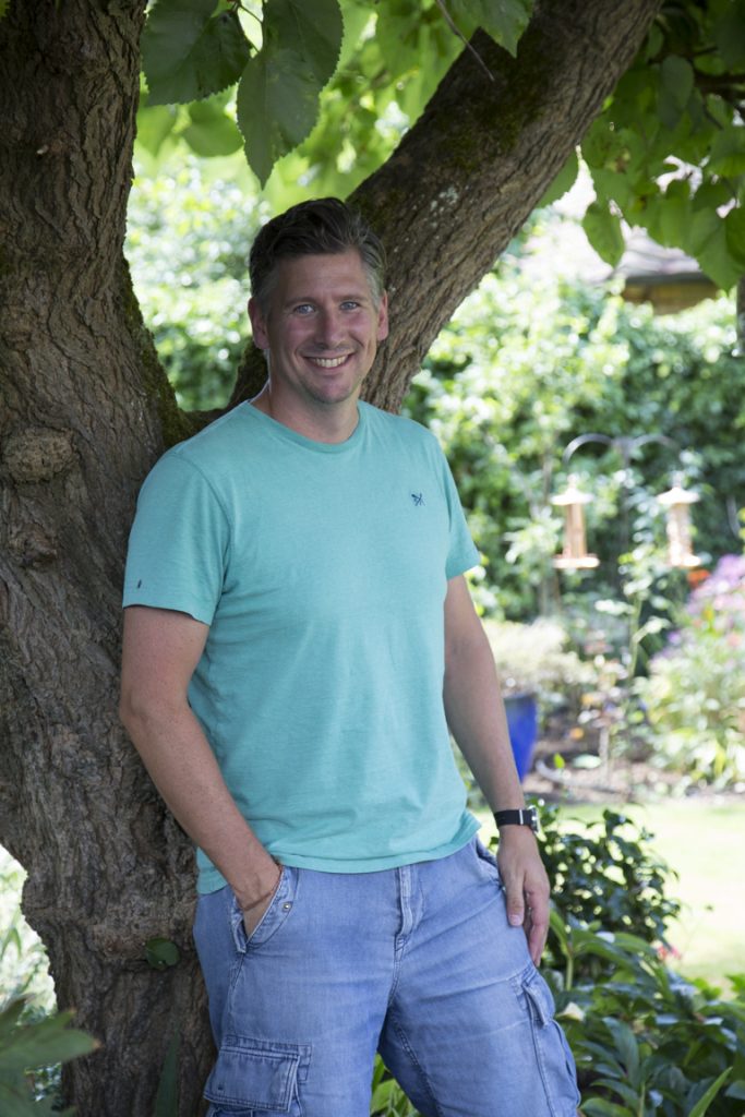 Ben from Boxwild leaning against a tree