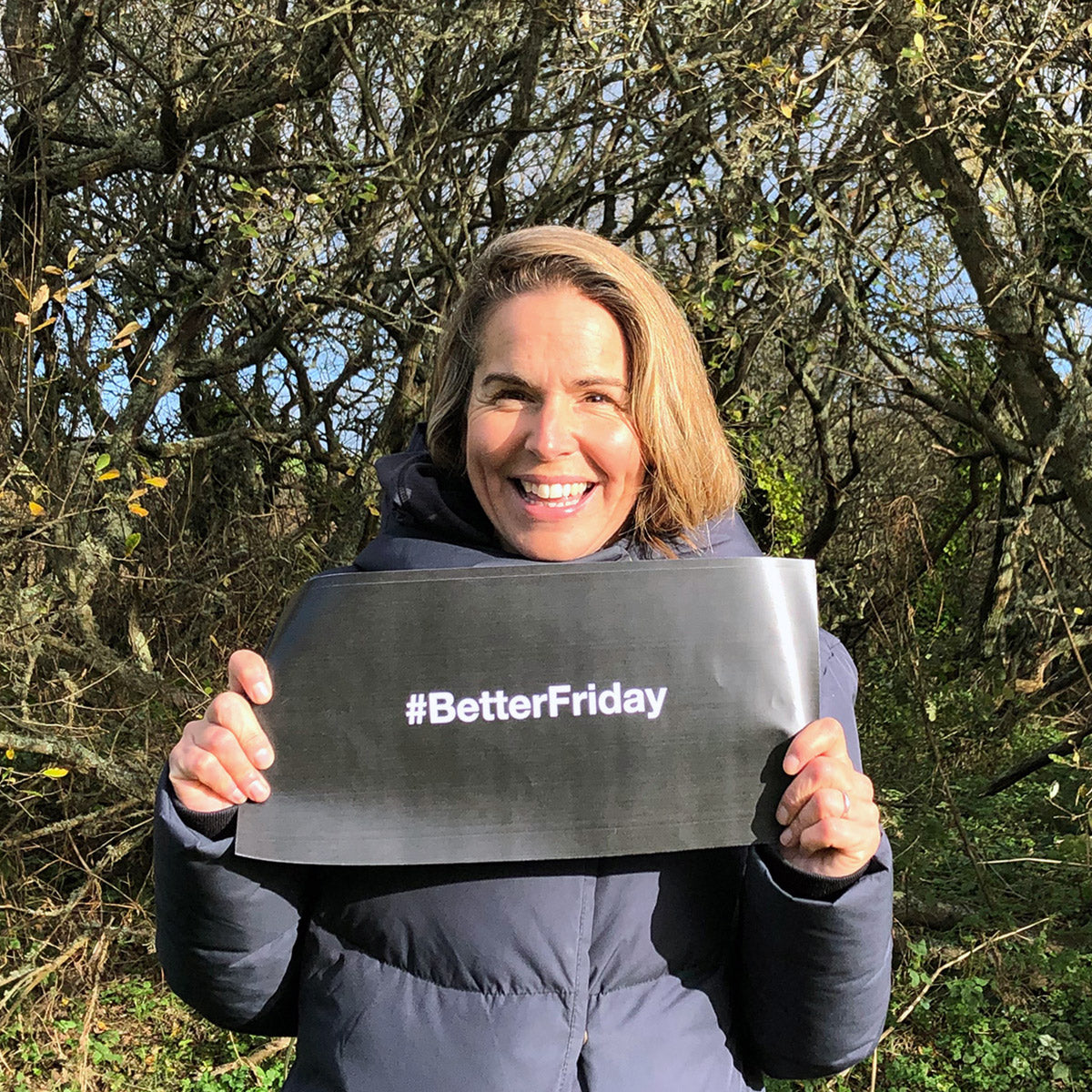 Kate holding better friday sign outside cornish nature reserve