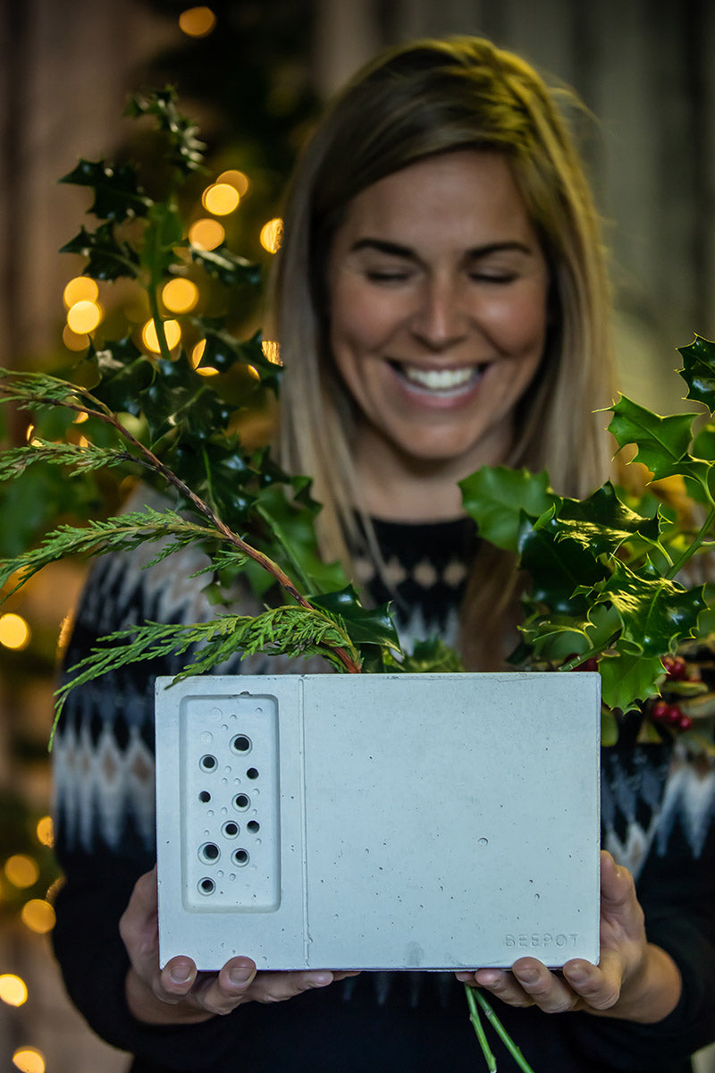 lady holds the beepot bee house and planter from Green&Blue range, planted with christmas holly