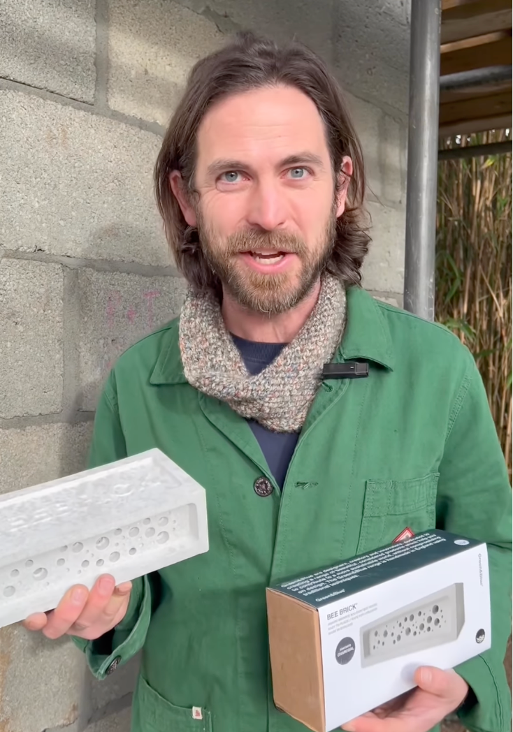James Strawbridge holds a bee brick and bee brick box
