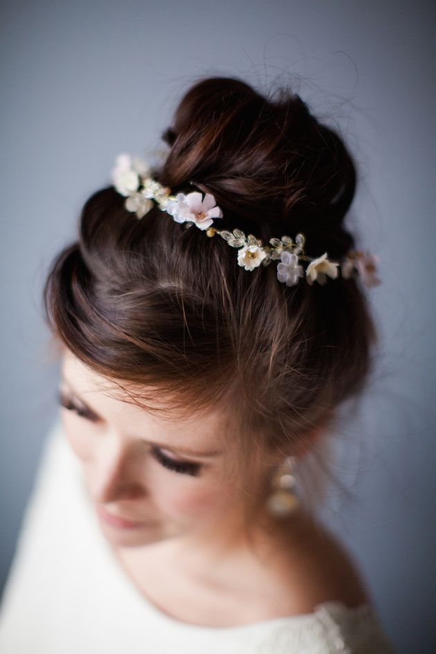 Buns made romantic with chic, floral accessory.