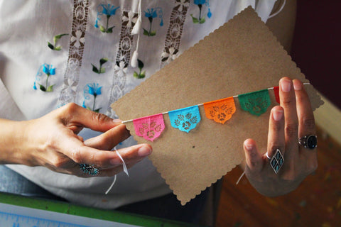 Artist Yreina Flores making papel picado