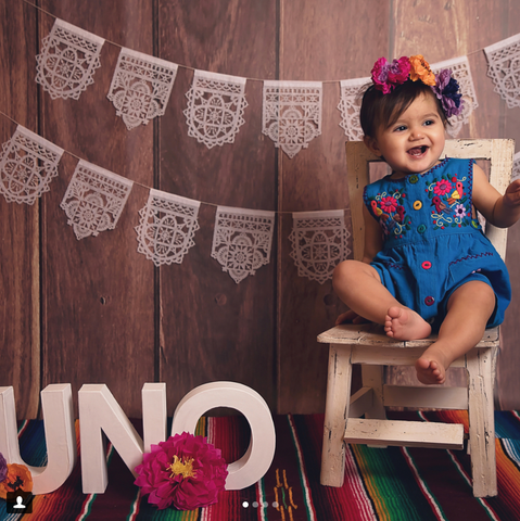 First birthday portrait with Ay Mujer papel picado
