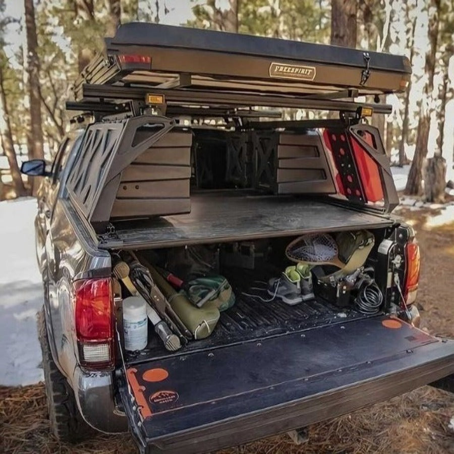 A tonneau cover on a pickup truck. The tonneau cover is black and made of durable material. It is designed to protect the truck bed from the elements and theft.