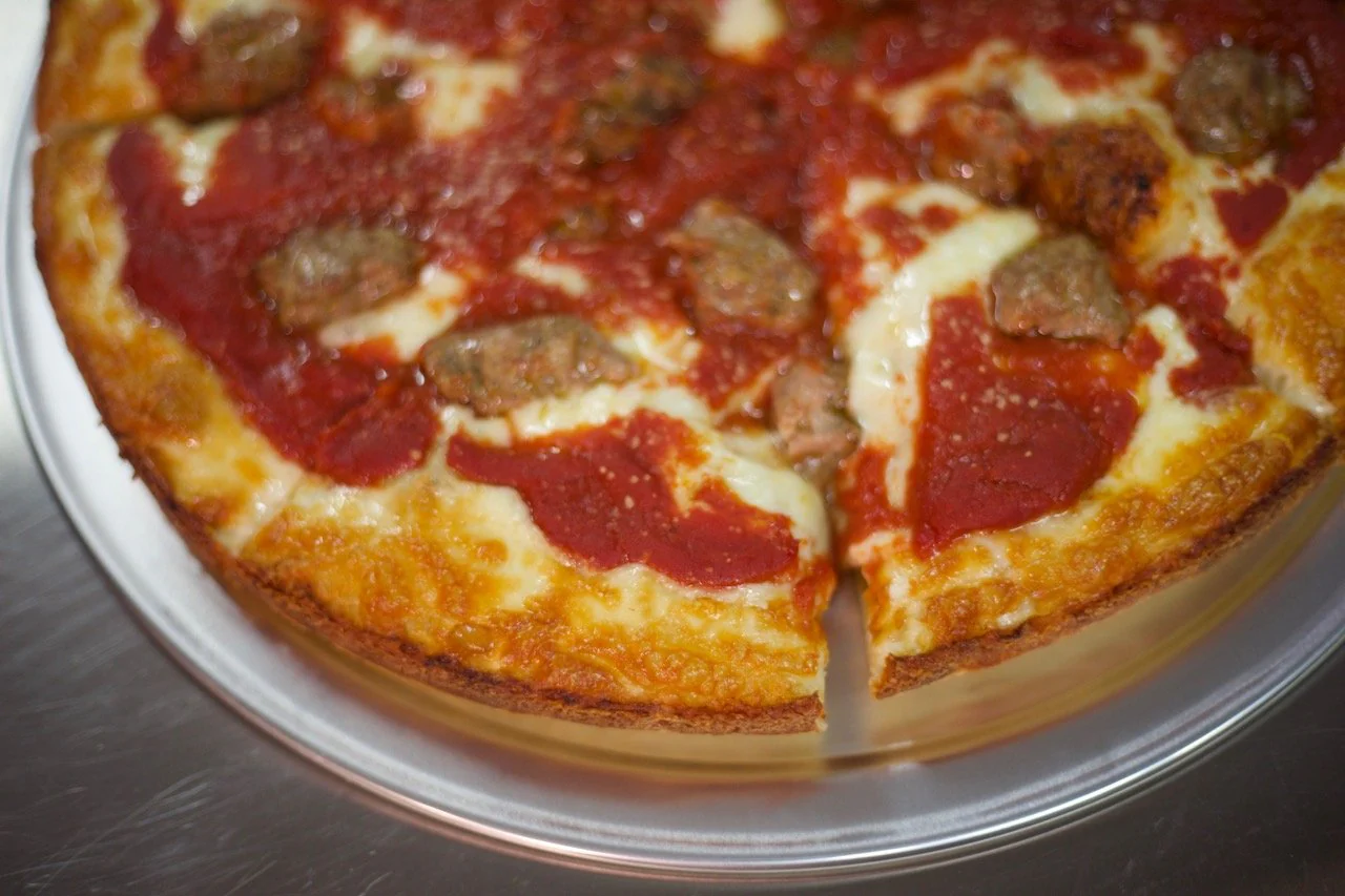 Chicago deep dish style pizza topped with sausage from George's Deep Dish