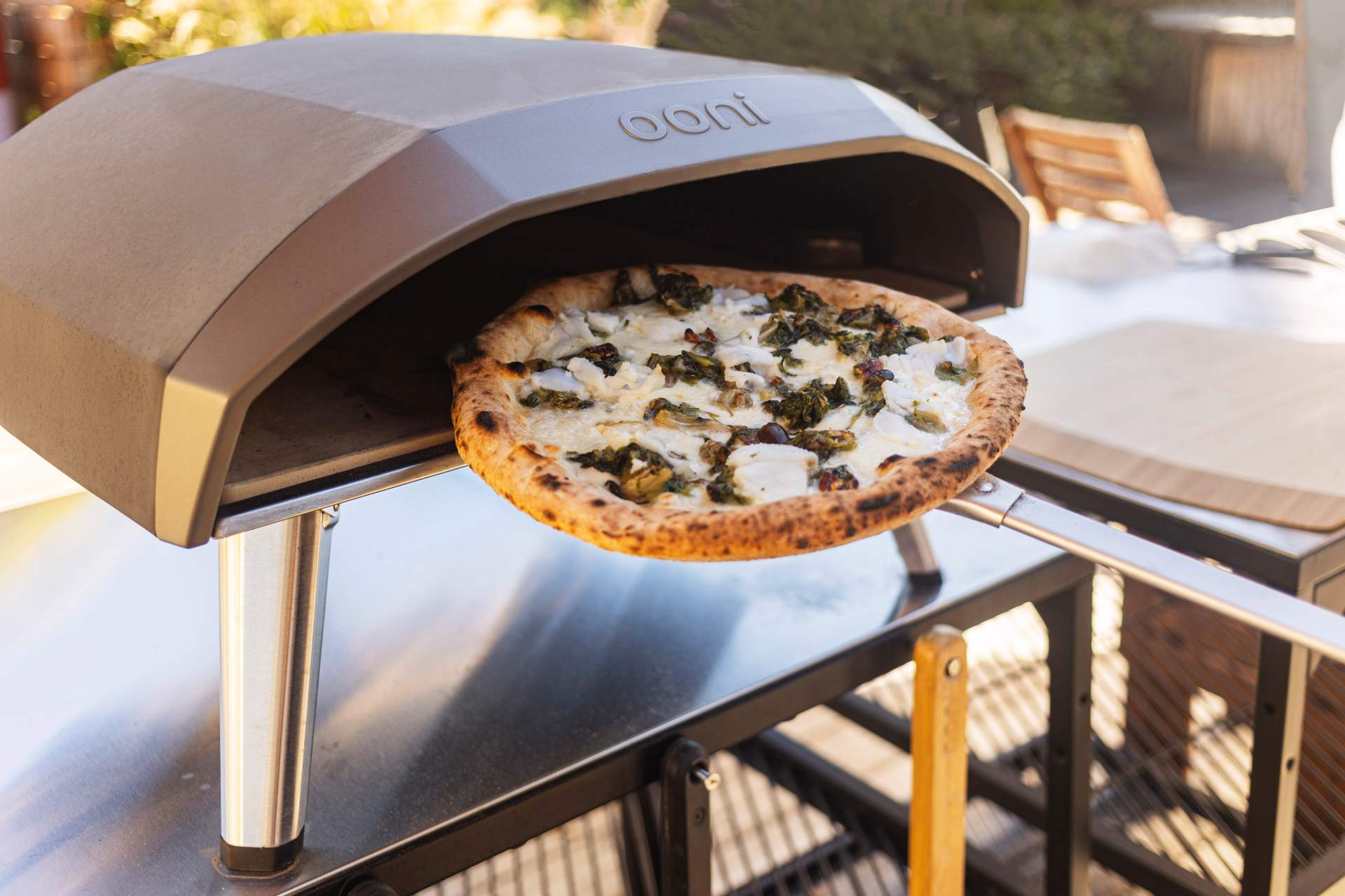 A calzone pizza with escarole and provola being cooked in the Koda pizza oven