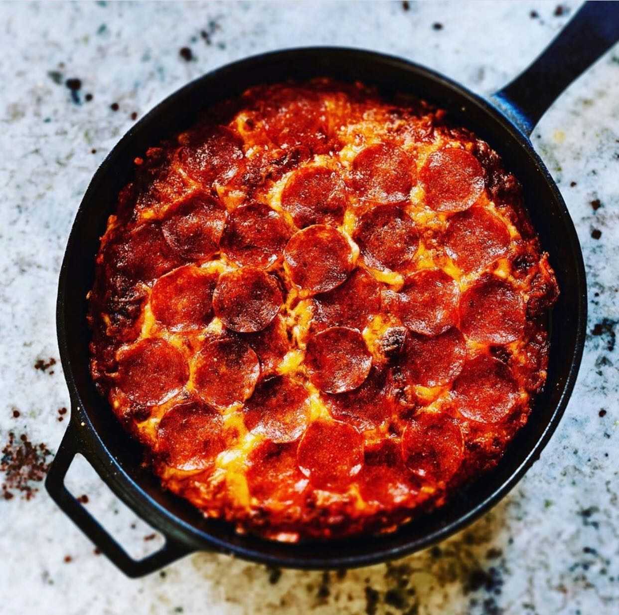 East skillet pizza with cheese and pepperoni in an Ooni Cast Iron Skillet Pan.