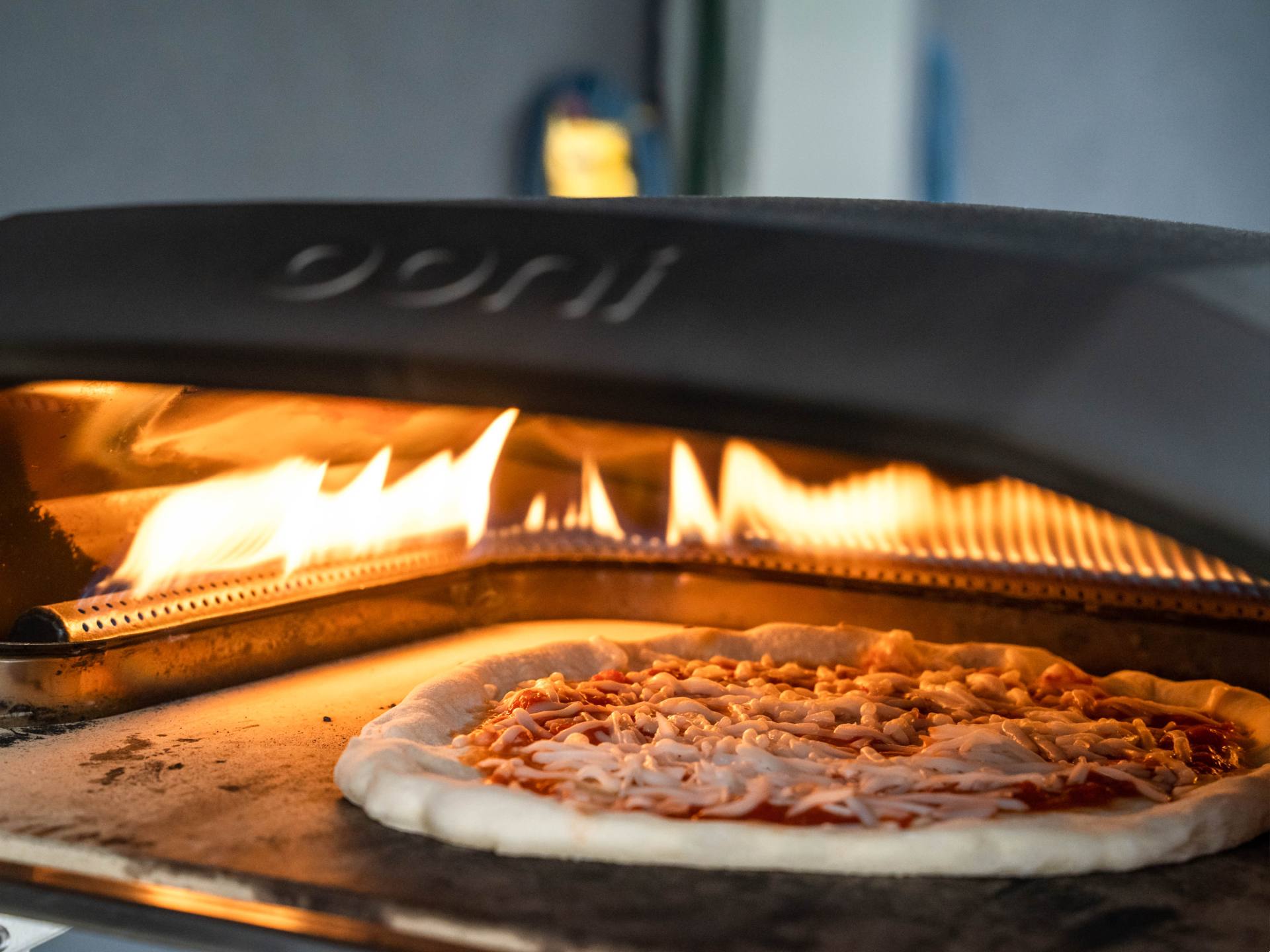 Pizza cooking in an Ooni pizza oven