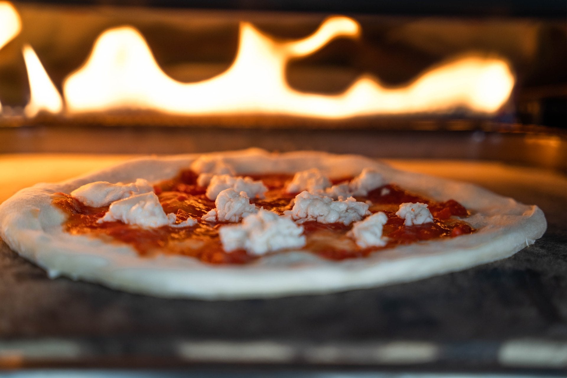 Pizza cooking in an Ooni pizza oven