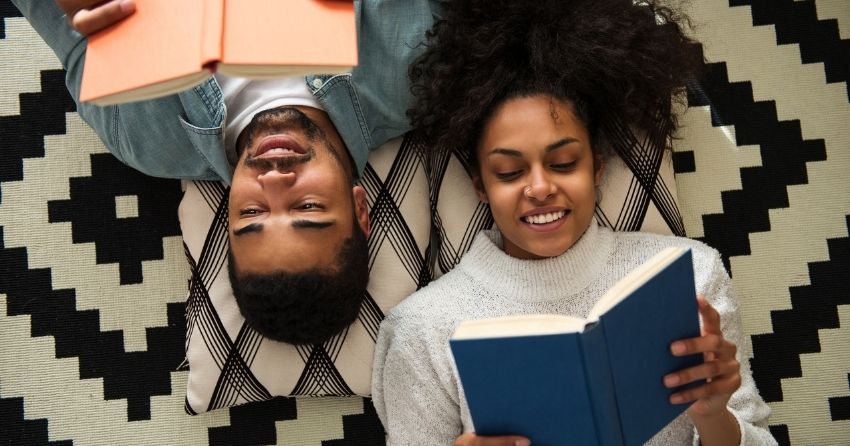 couple reading together on floor