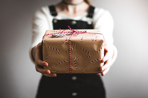 Woman holding a kraft wrapped present