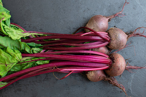 Bunch of beets of grey background