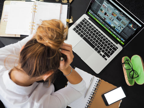 Woman sitting in front of computer stressed