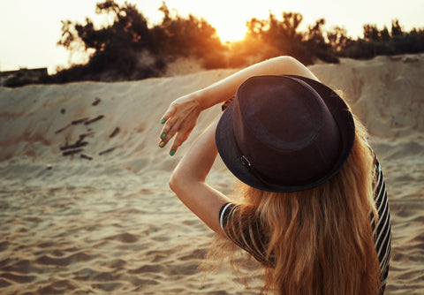 Woman covering her face with both hands