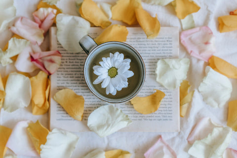 Cup of tea with flowers and petals