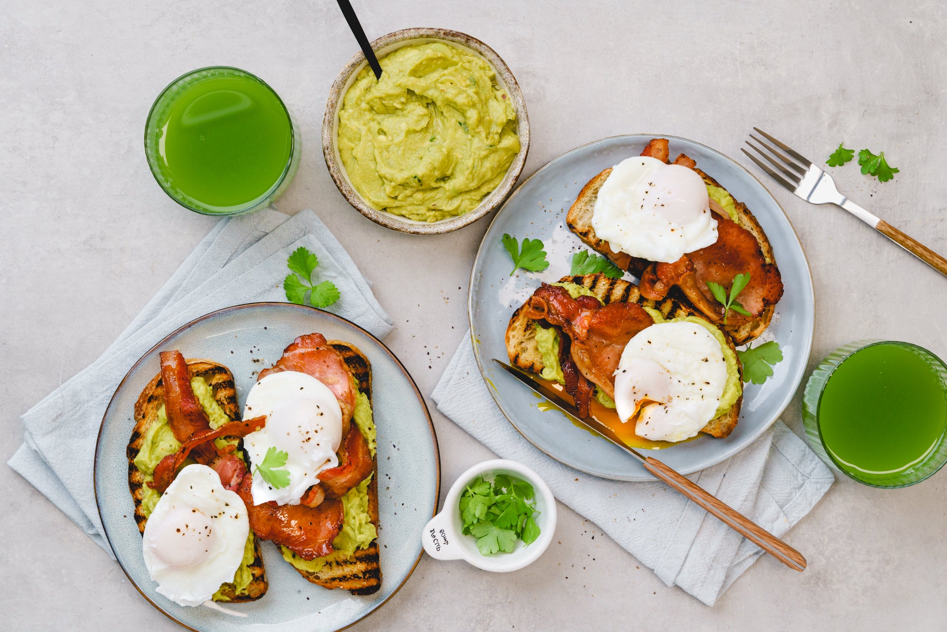 Poached eggs, bacon and guacamole on sour dough toast with green juice