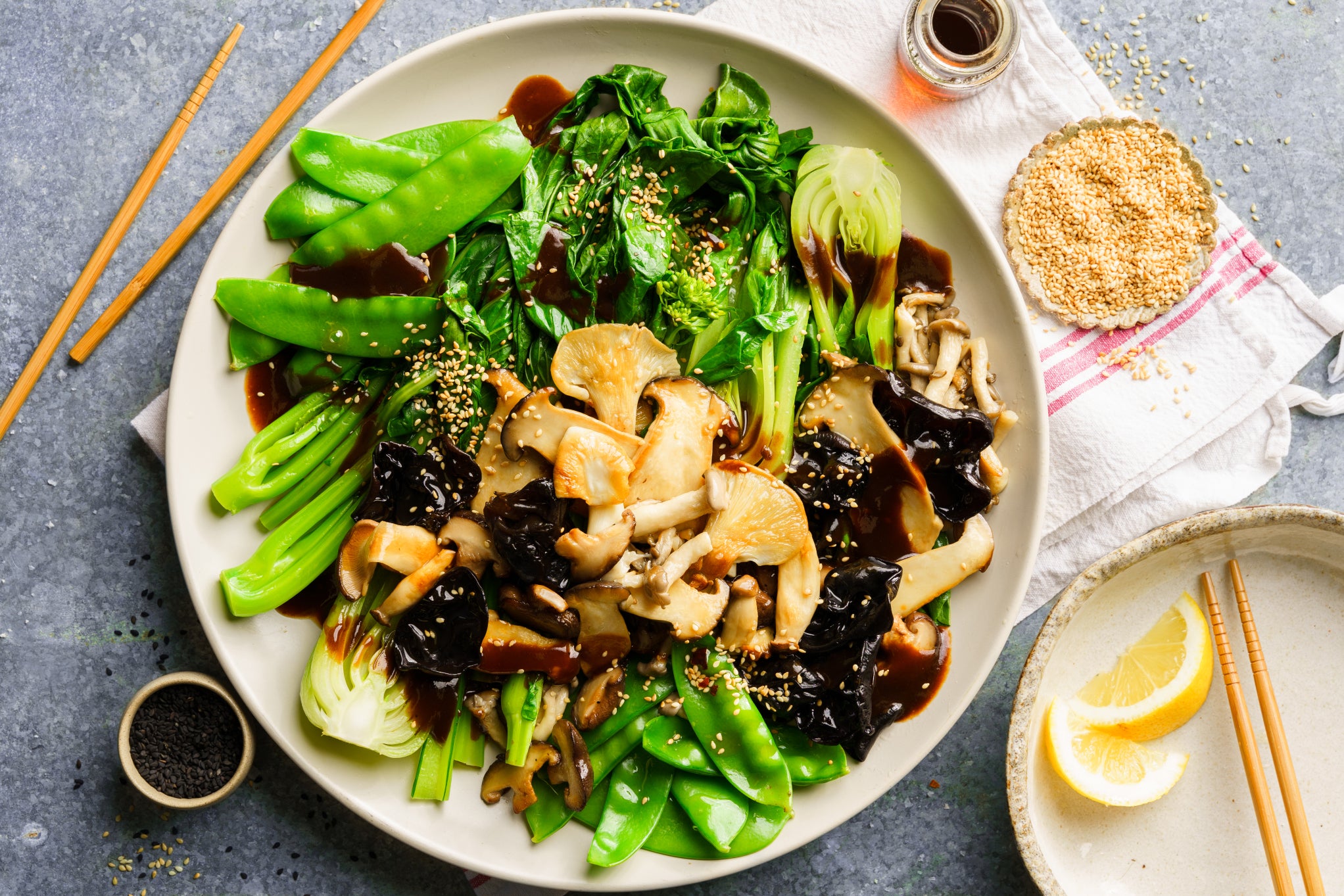 Asian greens, mixed mushrooms and black bean stir fry sprinkled with sesame seeds